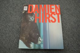 A Damien Hirst book, bears signature.