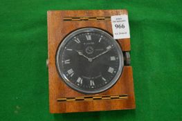 A Jaeger clock, possible from a car, in later mahogany mount.