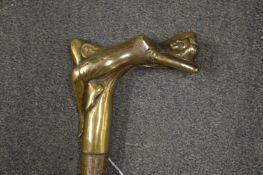 A walking stick, the brass handle modelled as a reclining female figure.