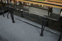 A stylish glass and metal framed coffee table.