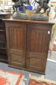 A linenfold decorated oak two door cupboard.