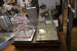 A pair of unusual pyramid shaped display cases.