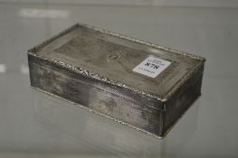 A silver table cigarette box with engine turned decoration, the hinged cover with Royal Fifer and