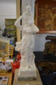 A good carved white marble figure of a young lady holding a young child above her shoulders.