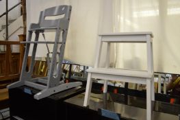 A childs high chair and a pair of painted steps.