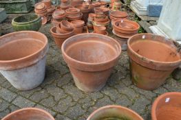 Three large terracotta plant pots.