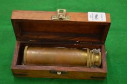 A boxed brass telescope.