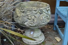 A pedestal composite garden planter.