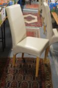 A set of six modern cream leather cloth upholstered highback dining chairs.