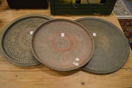 Three Eastern circular copper and brass chargers.
