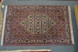 A small Persian rug with stylised decoration.
