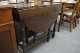 An oak drop leaf gateleg dining table.