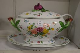 A floral decorated porcelain tureen, cover and stand complete with ladle.