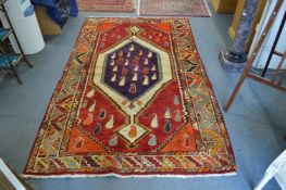 A colourful Persian design carpet 240cm x 150cm.