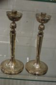 An unusual pair of Continental silver figural candlesticks.