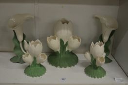 A set of five naturalistically formed flower vases.