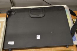 A collection of aviation and motoring pictures within a folder, unframed.