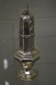 A silver octagonal shaped pedestal sugar castor.