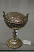 A good Continental silver plated pedestal cup and cover with embossed and applied decoration.