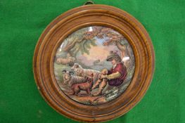 A porcelain pot lid, The Shepherd Boy, framed.
