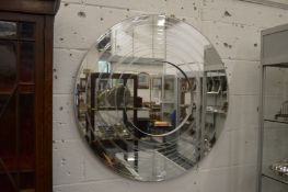 A large circular stylish wall mirror.