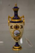 A small Coalport painted and gilded pedestal vase and cover (rim repaired).
