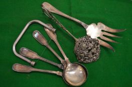 Embossed silver tongs and other items.