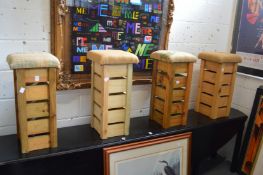 A set of four rustic pine and upholstered bar stools.