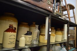 A quantity of old salt glazed storage jars etc.