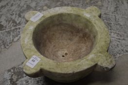 A carved marble mortar.