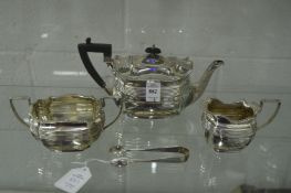 A bachelor's silver three piece tea service of shaped outline with ribbed decoration together with a