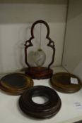 A Chinese reverse painted glass egg on stand and three Chinese stands.