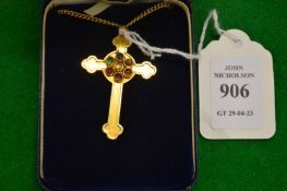 A 9ct gold cross on chain inset with various gem stones.