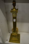 A brass corinthian column table lamp.