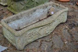 A composite garden trough with serpentine front.