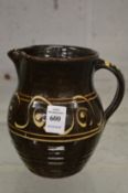 Michael Cardew, Winchcombe Pottery, a slip ware jug with impressed mark.