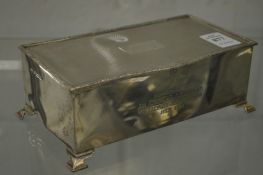 A silver table cigarette box with engine turned hinged lid, the front with engraved presentation