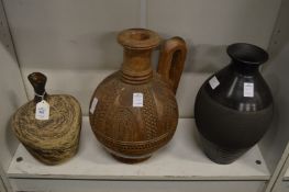 Studio pottery vase, an African carved wood jug and another vase.