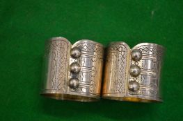 A pair of Continental silver napkin rings modelled as buttoned waistcoats.