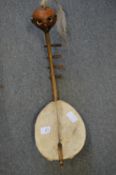 A small stringed musical instrument, possibly Ivory Coast.