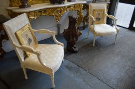 A pair of French style cream painted and upholstered open armchairs.