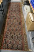 A Persian runner or hall carpet, dark blue ground with stylised Boteh decoration, ends reduced 300cm