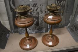 A pair of copper oil lamps.