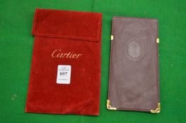 A Cartier glasses case with red velvet cover.