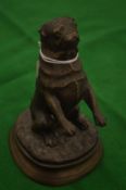 A cast bronze figure of a begging dog.