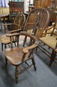 A Victorian ash and elm broad arm Windsor chair.