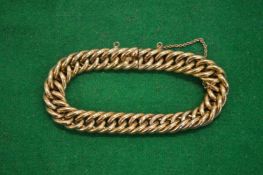 A yellow metal curb link bracelet.