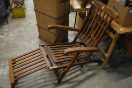 A teak steamer style garden lounger.