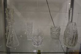 Decorative clear glass vases and a stylish decanter.