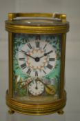 A good circular brass carriage clock with enamel decorated dial and case.